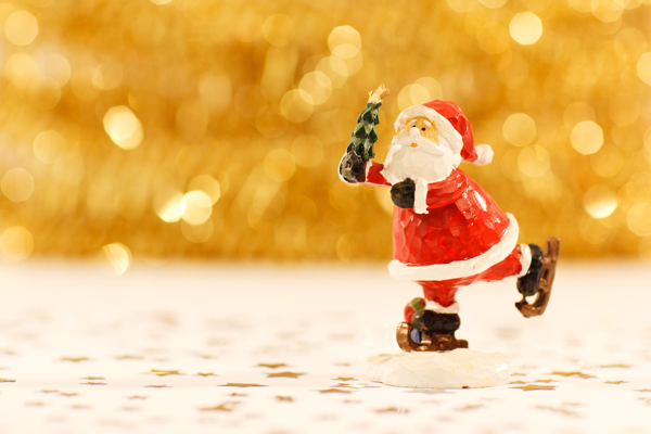 Santa ice skating with a Christmas tree