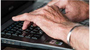 Hands touch typing on computer keyboard