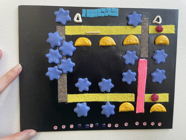 A tactile map of the Beyond Vision route through Warley Woods, made from textured air-dry clay pieces for trees, felt and sandpaper pathways, and a plastic diamante street road.