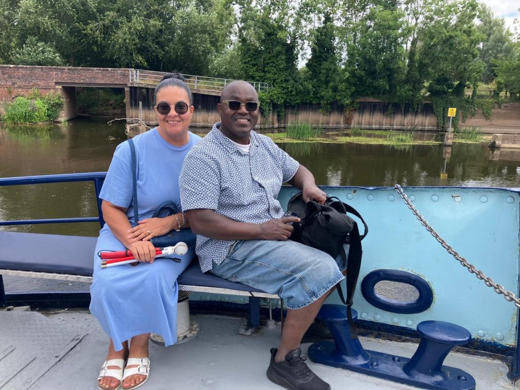 AN SVI member and her husband sitting on the deck of the River King trip boat